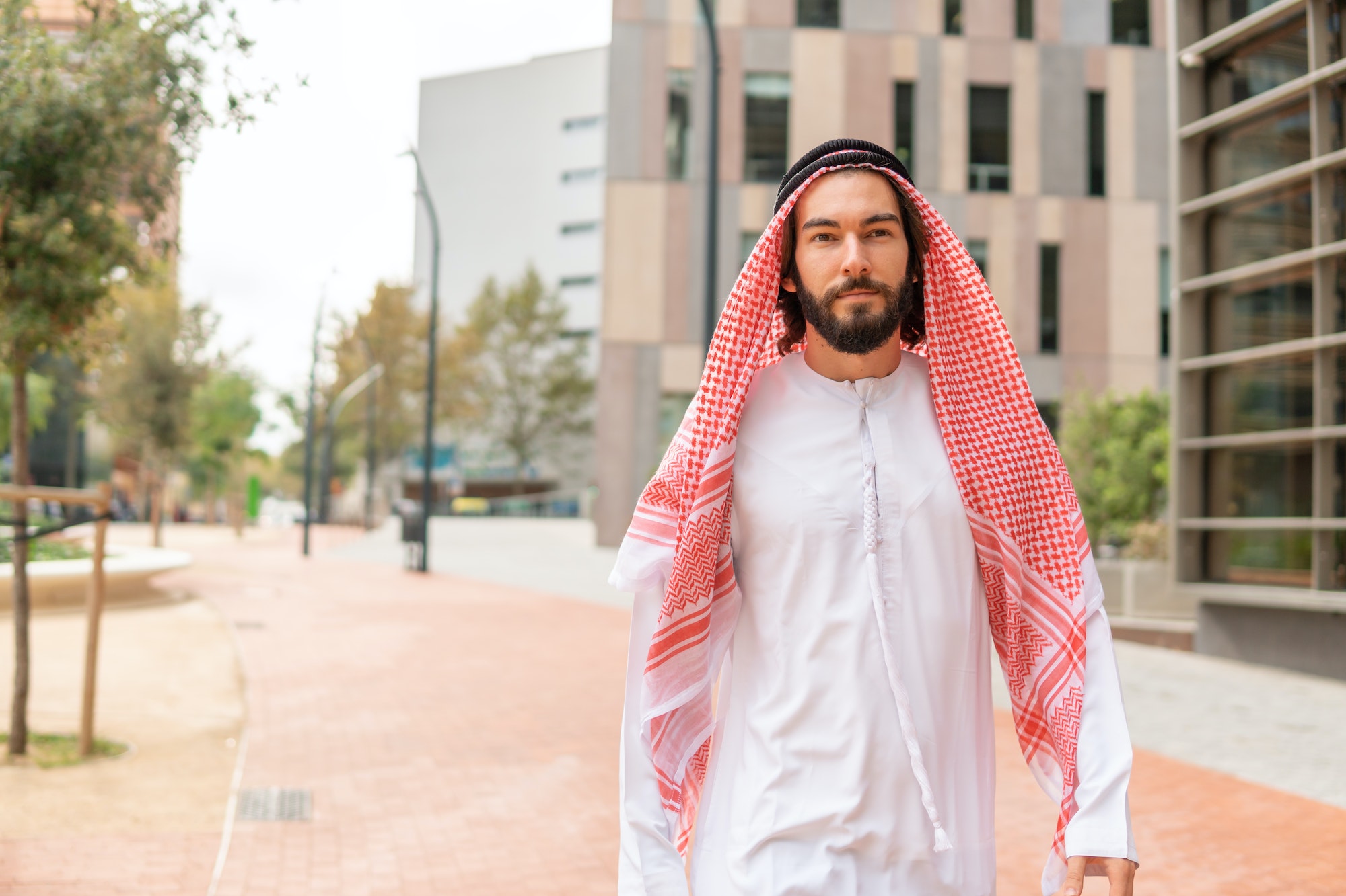 Arab man walking on street